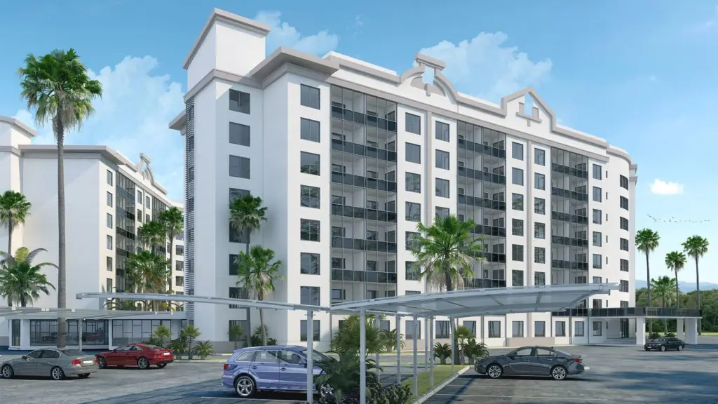 Front facade and covered parking carports at Cabana Club in Miami, FL with two 8-story cast-in-place concrete residential buildings and palm tree landscaping