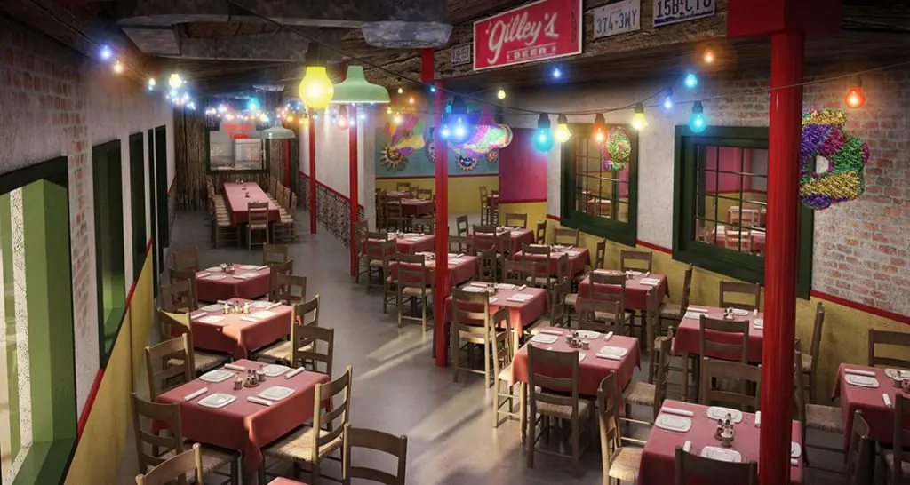 Cantina interior dining room with red tablecloths, exposed brick walls, colorful string lights, and red structural columns