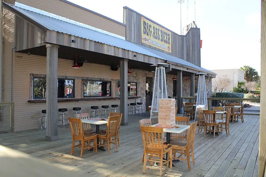 Outdoor patio bar at Diablo Loco with covered seating, wood plank decking, and patio heaters