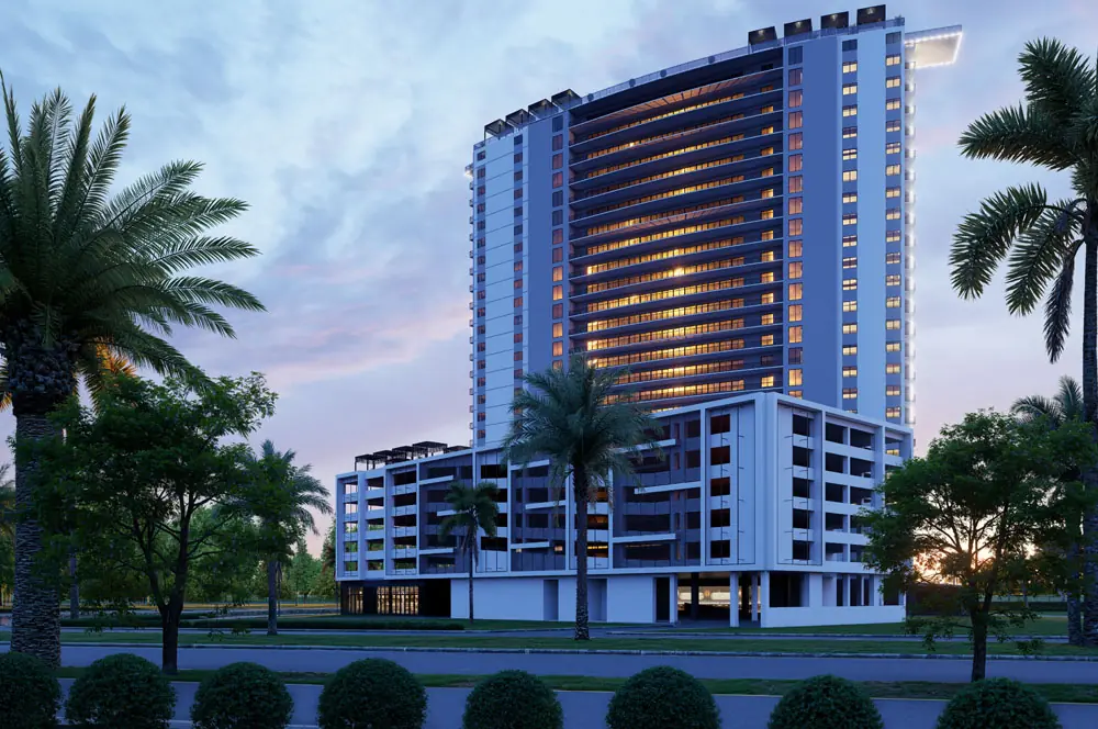 Dusk view of Marbella Tower's residential tower glowing above the parking podium