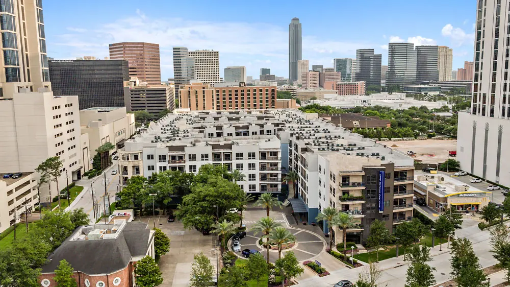 Aerial view of Post Oak Apartments with the Houston Uptown and Galleria skyline in the background