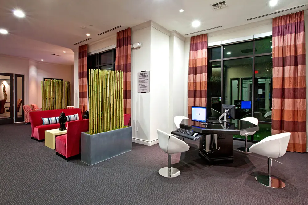 Business center and lounge at Post Oak Apartments with workstations and seating