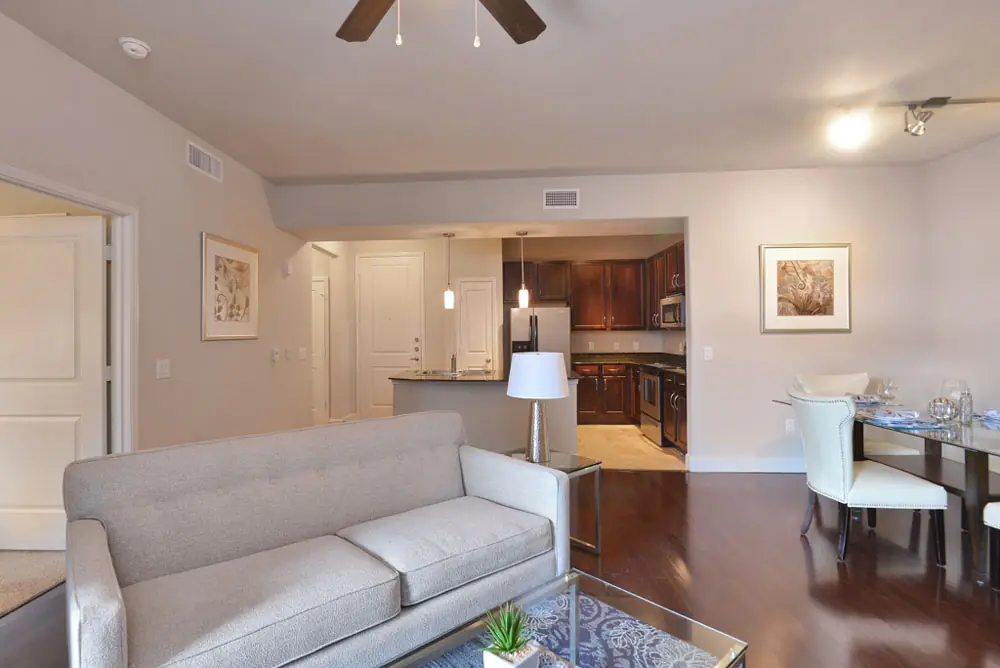 Open living, dining, and kitchen layout in a Post Oak Apartments unit